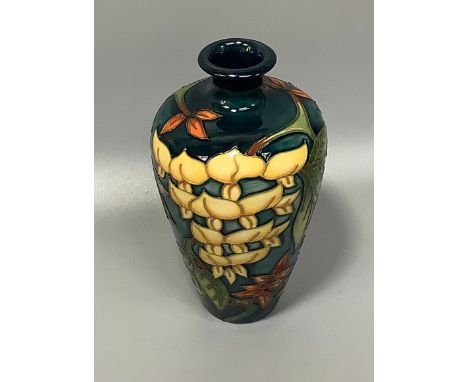 A Moorcroft Collectors Club pottery vase of baluster form and designed by Philip Gibson in the 'Wisteria' pattern, tube-lined