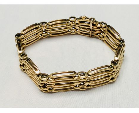 A 9ct yellow gold six-bar gate bracelet with safety catch, weighs 38.4 grams, hallmarked. 