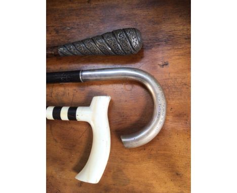 Three various late 19th / early 20th century walking sticks including one with a continental silver handle engraved '800 W.S'