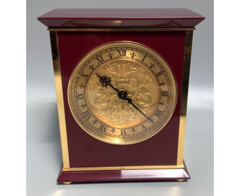 A Swiss Luxor mantel clock with maroon and gilt casing, gilt face and chapter ring with Roman numerals, 18cm high 