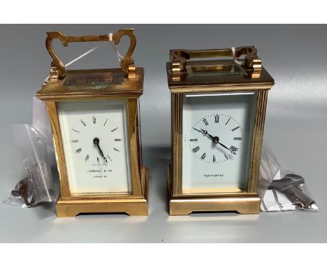 A brass cased carriage clock with glass front, back, sides and top, white enamel dial with Roman numerals and marked 'Garrard