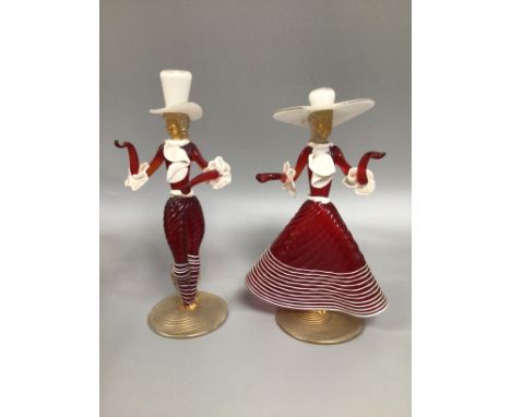 A pair of Venetian red and opaque glass figures, male and female in dancing poses with frilly neck ties and cuffs (one af), t