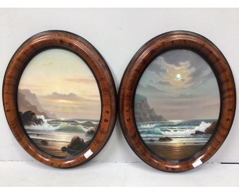 Alan Dinsdale (b.1939) A pair of oval day and night seascape studies with mountains, signed, oils on board, framed, 38 x 28cm