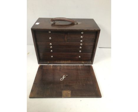 A stained oak engineers tool cabinet / collectors cabinet with nine various drawers, lift out front cover and leather carry h