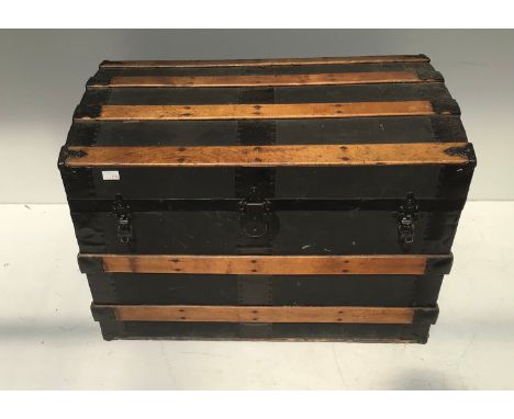 A wooden and metal bound domed top travelling trunk with twin leather handles, 77cm wide 