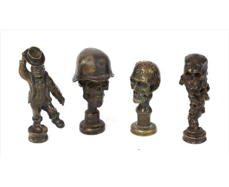 SKULLS , 20th century, probably Austrian, an unusual group of four bronze pipe tempers, modelled as skulls and a dancing monk