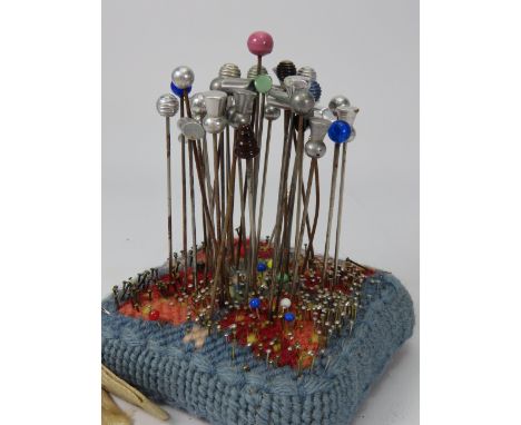 Vintage pin cushion and a selection of hat pins.