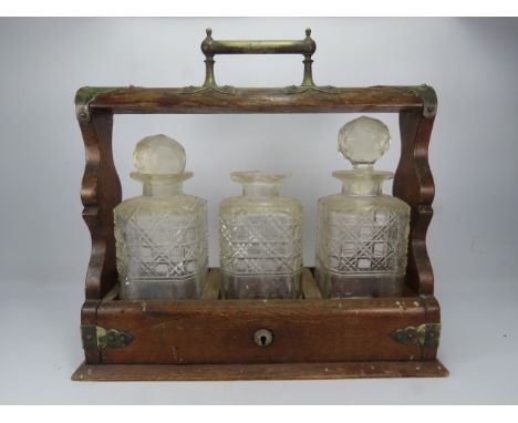 Three bottle decanter tantalus, no key and damage to one decanter.