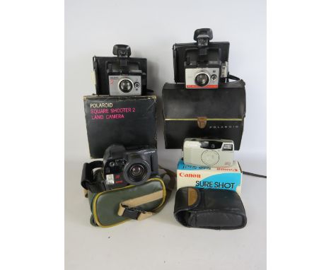 Four Vintage cameras, two Polaroid, one Canon Sure Shot 60 and an Olympus AZ-300 super Zoom