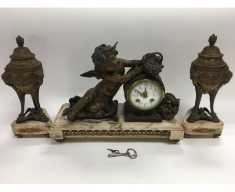 An 8 day marble and spelter figural clock and garnitures, the clock depicting a seated cherub with baskets of fruit, the enam