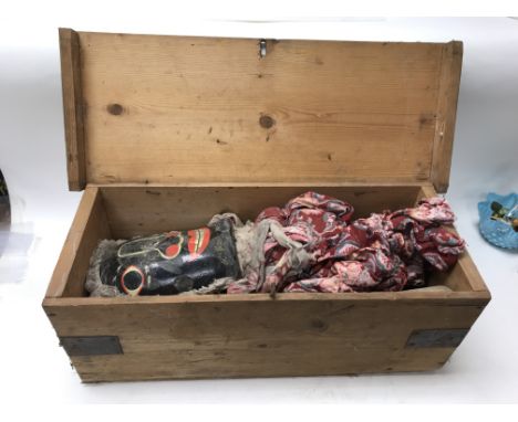 A boxed aunt sally wooden puppet in a crate with puppet master sticks.