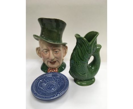 A Beswick character jug of 'Micawber', a Wade coronation dish and a Dartmouth glug jug (3).