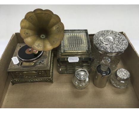 A collection of silver topped bottles, a musical gramophone table lighter and a glass desk inkwell.