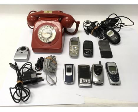 A collection of vintage mobile phones and one 1970's Rotary dial telephone.