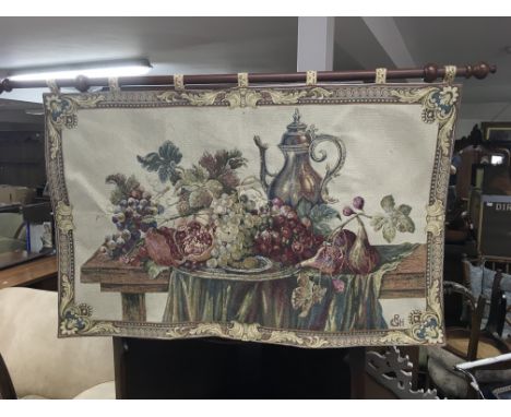 A Tapestry depicting a still life scene of fruit, size approx 104x66cm, along with another large example with floral design.