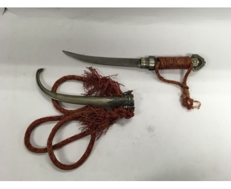 An eastern sword with scabbard and fabric wrapped hilt.