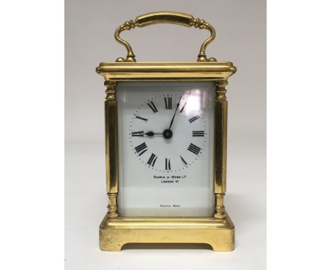 A brass bound carriage clock by Mappin & Webb with Roman numerals with Tuscan style columns.