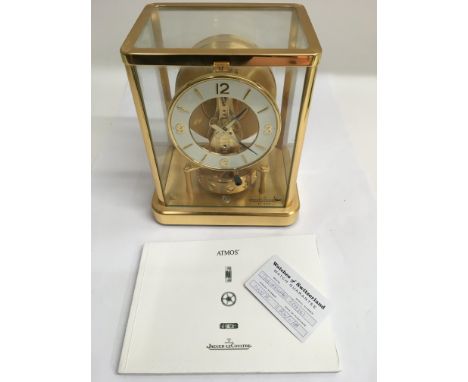 A Jaeger-LeCoultre Atmos clock with booklet and guarantee.Approx 16x23cm