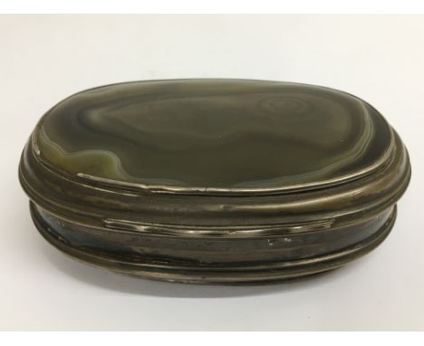 A 19th century polished agate oval shape trinket box mounted in white metal.Approx 11cm long