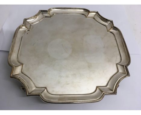 A silver Chippendale style tray raised on four ball feet, London Goldsmiths and Silversmiths Company, 1910. Approx 31x31cm, o