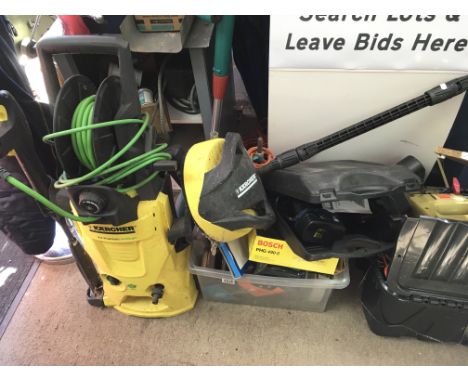 A petrol ATCO lawnmower, a Karcher power washer and a collection of various tools some in metal filing cabinets.