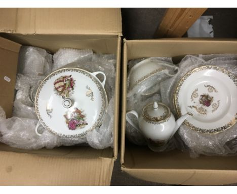 Two boxes containing a a dinner and tea service plus four items of blue and white Wedgwood Jasperware comprising a chesse dis