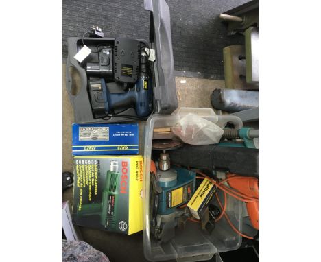 A box containing a collection of power tools including desktop grinder, torque wrench and power drill