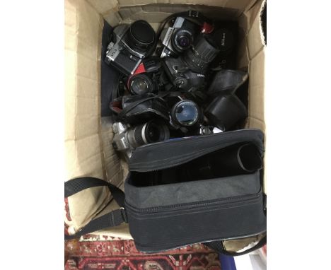 A box of SLR cameras including Nikon and Minolta