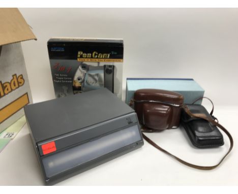 A collection of various camera equipment including a boxed pen cam, a light box, a canon camera and a Kodak camera.