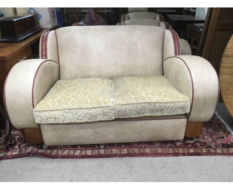 A Art Deco three pice suite comprising two seater sofa and two matching chairs