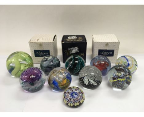 A collection of ten glass paperweights including Caithness examples.