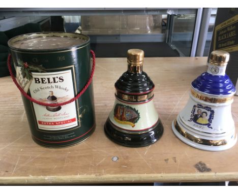 Three decanters of bells scotch whiskey