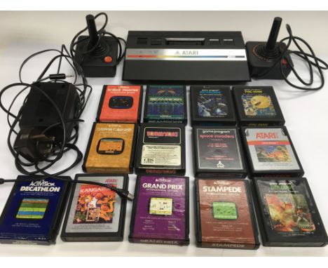 An Atari 2600 console and games, a Binatone MKIV, an Amstrad 464 home computer, Amstrad monitor, games and accessories.
