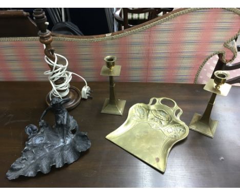 An Art Nouveau spelter inkwell, brass candlesticks, crumb tray and lamp