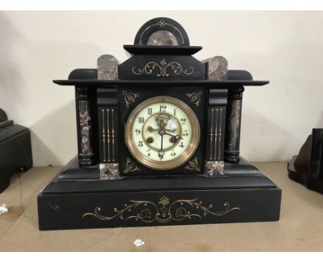 An Art Deco mantel clock decorated with marble.