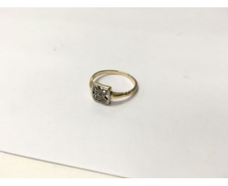 A gold ring set with white stones. Size approx K