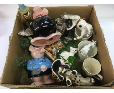 A box of various ceramics and glass including a Murano clown, two Wade Natwest pigs, an Art Deco style glass dressing table s