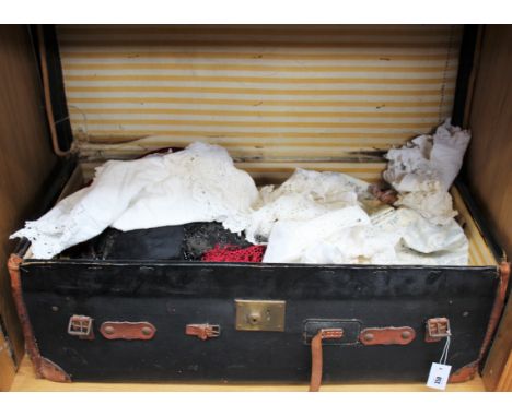 A large canvas and leather bound trunk containing lace, linens and vintage fabrics. 