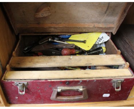 A large painted wooden tool box containing various tools together with another wooden box.