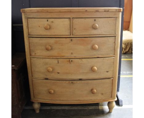 A Victorian pine bow fronted chest, with two short drawers over three long graduated drawers, raised on turned feet (one foot