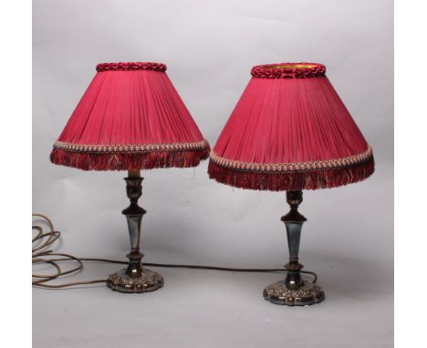 A pair of silver plated candlesticks converted to lamps together with seven ornate lamp shades. 