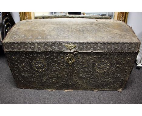 An Early 18th Century studded leather trunk, with a domed lid, decorated all over with birds amongst flowers, 110cm wide.
