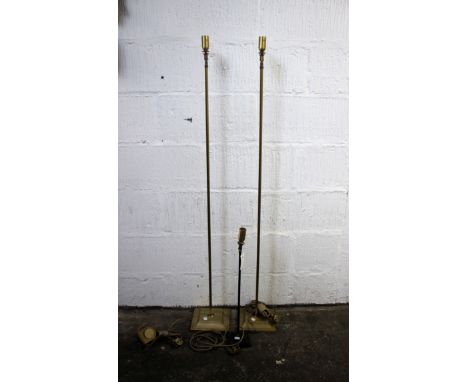 A pair of brass floor lamps on square bases, 138cm high; with a small matching black table lamp. 