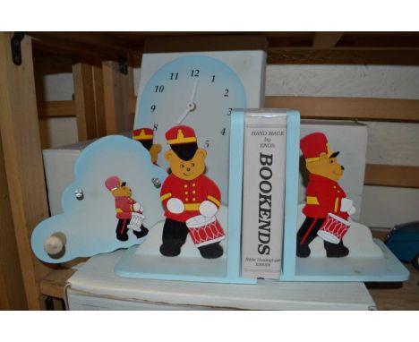 A pair of childrens wood teddy bear bookends together with a matching wall clock and coat hook