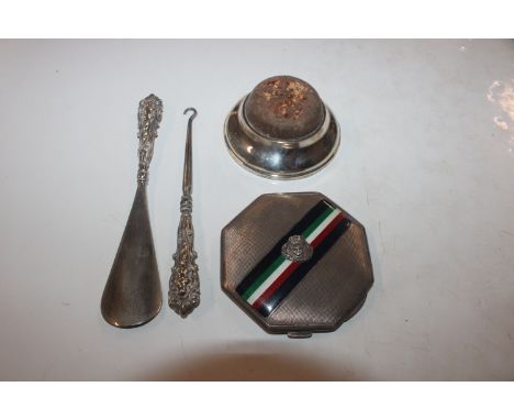 A silver mounted pin cushion; a silver and enamel decorated compact; a silver handled shoe horn and silver handled button hoo