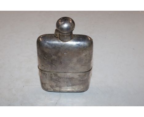 A silver hip flask with detachable cup