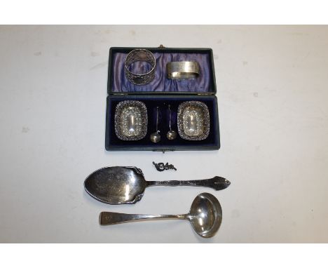 A George III silver sauce ladle; a cased pair of silver salts and spoons; a silver napkin ring inscribed "Bill"; another napk
