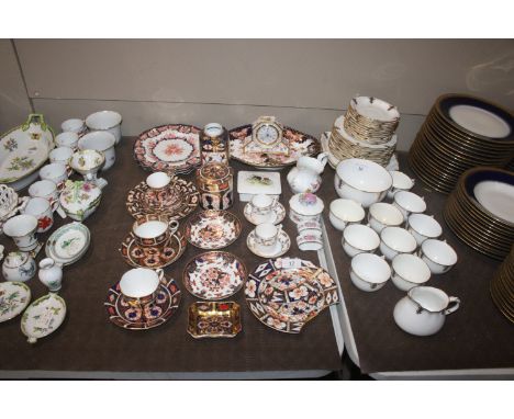 A collection of Royal Crown Derby items including cups and saucers, side plates, serving plates, cylindrical jar and cover, s