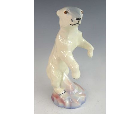 A Czechoslovakian Art Deco glazed ceramic figure of a polar bear, modelled standing on its hind legs, on rocky outcrop, under