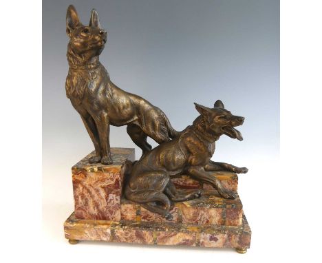 Louis-Albert Carvin (1875-1951) - a large Art Deco gilt spelter sculpture modelled as a pair of alsatians, one in standing po
